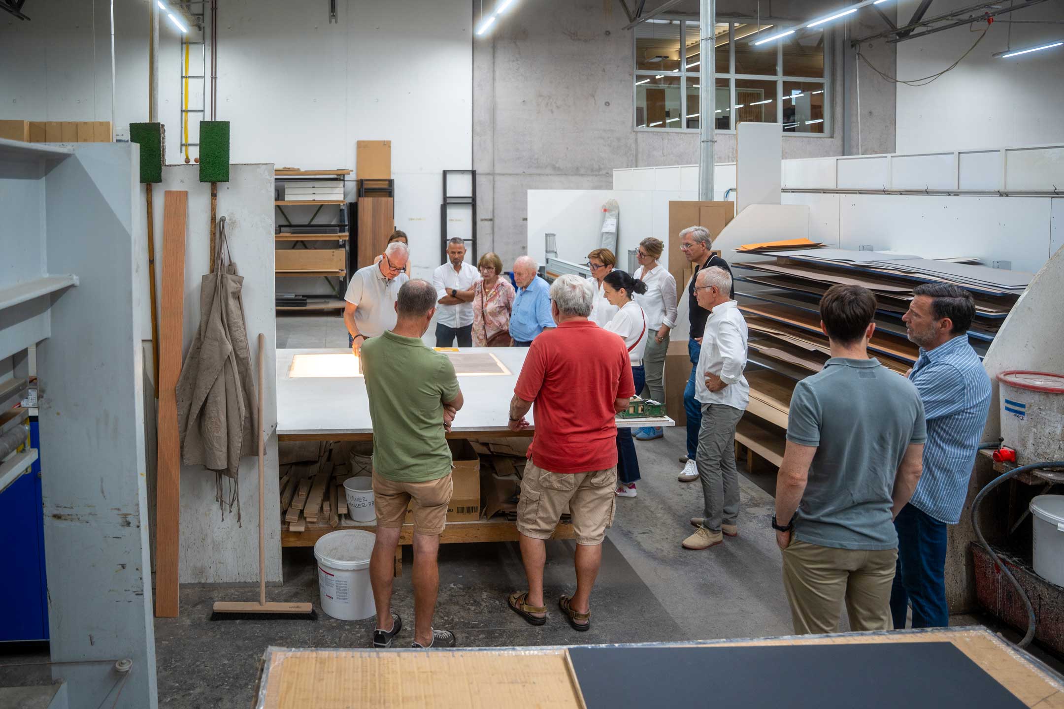 Besucher verfolgen eine Vorführung in der Werkstatt der Becherer Möbelwerkstätten